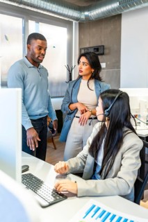 Business team collaborating in a modern coworking space, with a customer service representative