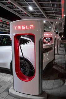 A Tesla electric car is charged at night at a charging station, Tesla, Leonberg, Germany