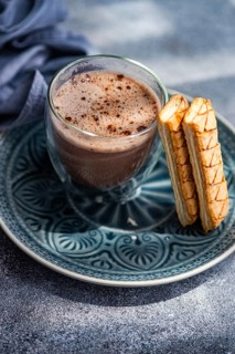 A delectable puff pastry filled with rich apricot jam alongside a steaming cup of freshly brewed