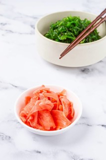 Chuka salad, made from fresh seaweed, with sesame dressing, in a white bowl, with chopsticks and