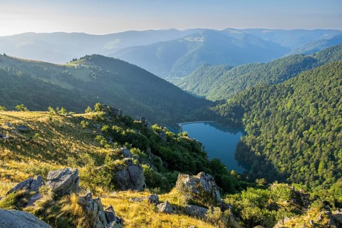 Water reservoir down in the valles on a sunny morning from Mount Hohneck in the Vosges Mountains,