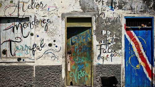 Atelier mendinga Tarrafal, colorful wall paintings and lettering on weathered wall with two