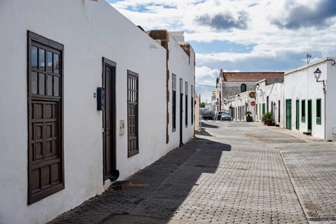 Typical white houses with colored doors and windows in an alley, Teguise, Lanzarote, Canary