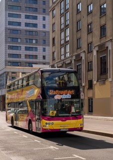 Sightseeing bus during its sightseeing tour in Berlin City East, Berlin, Germany