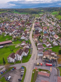 Central road network of a village with roundabout, surrounded by groups of buildings, Ostelsheim,