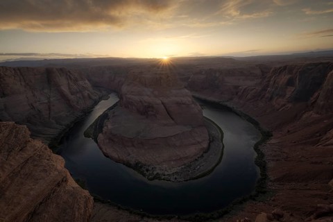 Aerial view of Horseshoe Bend at sunrise, capturing the stunning curves of the river surrounded by
