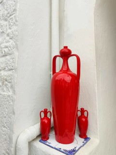 Red ceramic amphorae in front of a white trullo, Alberobello, Apulia, Italy