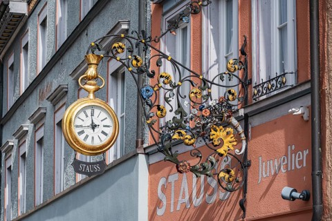 Traditional guild signs for watchmakers, nose sign with an oversized, gold pocket watch with Stauss