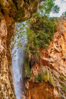 View of the interior of the Iris Grotto at the Cola de Caballo Waterfall in the Monasterio de