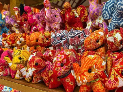 Vibrant display of intricately patterned elephant plush toys, showcasing traditional Thai designs