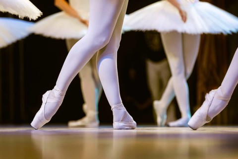 Legs of ballerinas dancing in ballet Swan Lake