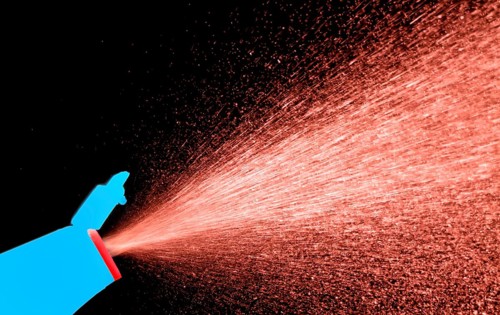 A fine spray of glass cleaner, colored against black background