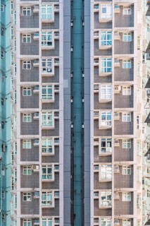 Tall residential building in Hong Kong demonstrates urban density and architecture. The facade
