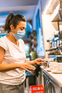 Photo session with a waitress with a face mask in a bar. New normality, security measures after the
