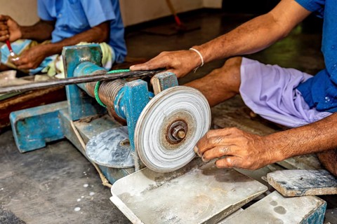 Hand worked a material with a whetstone in a workshop scene, The gemstone cutters in the city of
