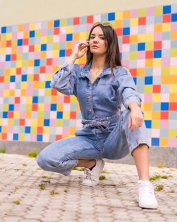 Young caucasian girl with a monkey cowboy in colored tiles. Enjoying the city on vacation,