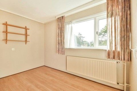 A spacious, bright room featuring large windows that allow ample natural light, complemented by