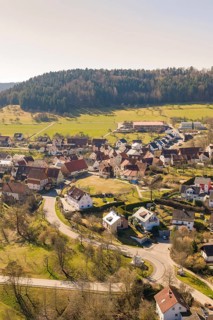 Idyllic village in a hilly landscape with winding roads and residential buildings, Pfrondorf,