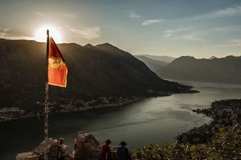 Flag of Montenegro over Bay of Kotor view from the hill above the town, Montenegro.