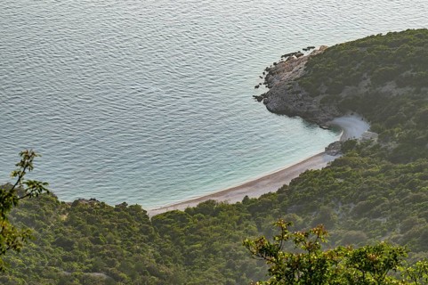 View from Lubenice across the sea with coastal landscape and bays on a sunny day at sunset on the