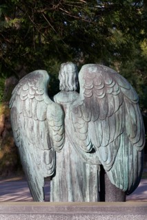 Spread wings of a ditch angel, back view, metal sculpture, Melaten Cemetery, Cologne, North