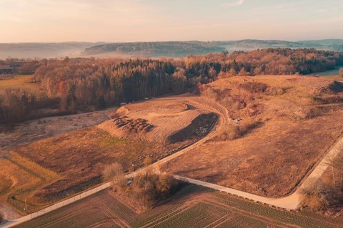 Aerial view of a vast landscape with hills and fields in soft morning light, landfill, Gechingen,
