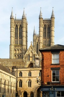 Towers of cathedral church rise above the medieval Exchequer Gate, Lincoln, Lincolnshire, England,
