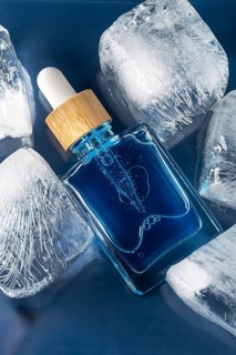 Top view of a face care serum or oil for men showcased in a clear dropper bottle, emphasizing its