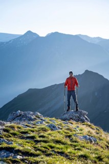 Hiker enjoying the mountain panorama in the morning, Venediger group, behind Dreiherrenkopf,