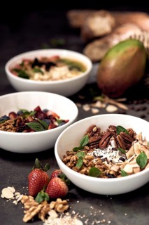 Three natural bowls filled with delicious and nutritious breakfast options, featuring fresh fruits,