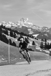 Road bike rider in spring in the Allgäu against the picturesque backdrop of the Alps, Bavaria,