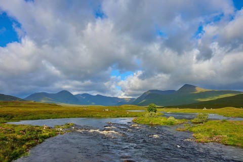 River flowing through a green landscape with mountains and clouds in the sky, Rannoch Moor, Bridge