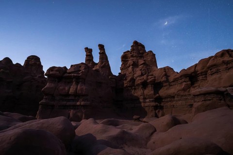 A majestic view of Goblin Valley State Park under a starry sky in Utah, showcasing the unique rock