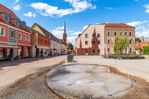 Fountain and façade art with the silhouette of the Catholic Church of the Assumption of Mary,