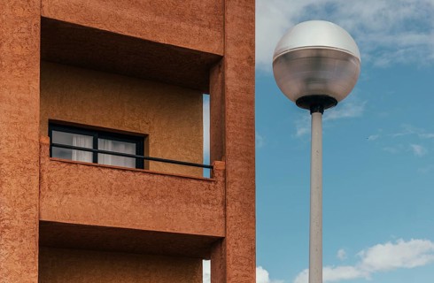 A stunning example of urban design featuring a textured brown building facade with a window and a