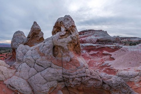 Dramatic landscape of White Pocket, Arizona, featuring intricate rock formations with red and white