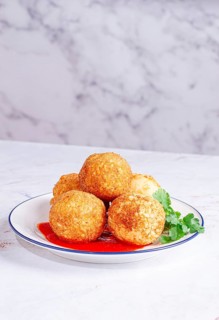 Arancini appetizer with tomato sauce, on a white plate, homemade, no people