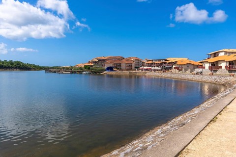 Vieux boucau les bains village architecture lining the tranquil lake, featuring residences and