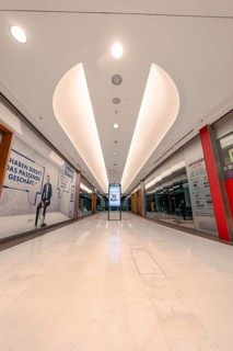 Empty illuminated corridor in a modern shopping centre with bright ceiling structure, Stuttgart,