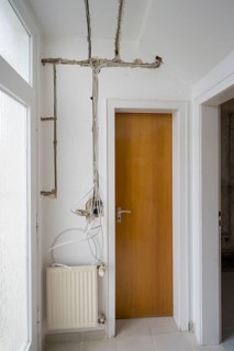 Apartment is being renovated, slots for electrical lines, unplastered exposed sockets, old