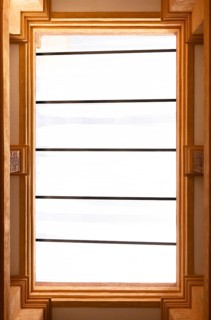 High-angle view of a rectangular skylight with a warm-toned concrete frame and white glass. The