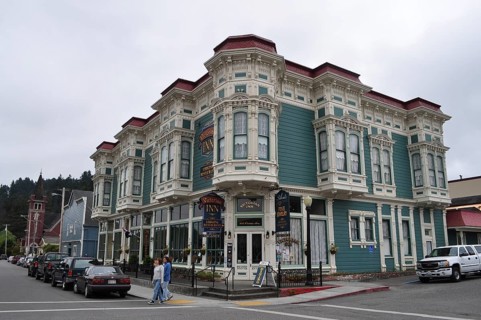Victorian inn with green-blue façade and ornate details on a cloudy day, Ferndale, California, USA