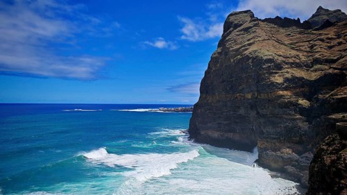 Steep cliff above the blue ocean with powerful waves under a clear sky, hiking, Santo Antao, Cabo