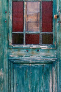 Old wooden door with glass windows and worn patina, Turkey