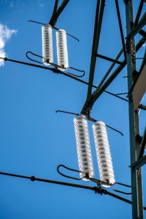 Insulators made of glass on a high-voltage line, they hang on the pylons as a suspension device