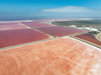Saline ponds and salt heaps at the salt works of Walvis Bay Salt. Aerial view. Drone shot. Walvis