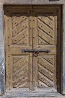 Old wooden door. Historical centre, Chiavenna, Valtellina, Lombardy, Italy