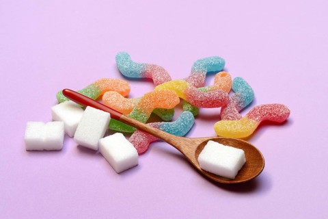 Lots of colorful jelly candies and sugar cubes, sugar consumption