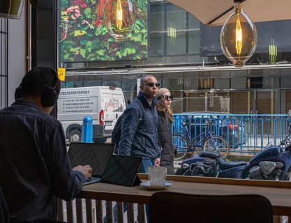 View through the window of a café of passers-by on Friedrichstraße in Mitte, Berlin, Germany