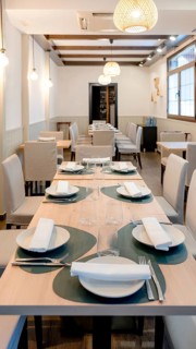 Elegant restaurant interior featuring neatly arranged tables with elegant dinnerware, soft